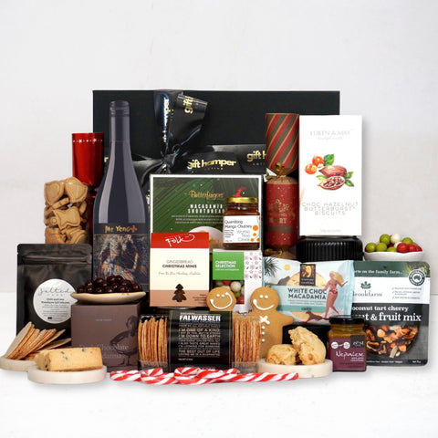 Assorted gift items including a bottle of Australian wine, Byron Cay cookies, and various packaged goods on a white background.