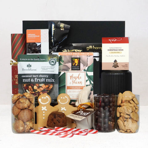 Assorted vegan gift items including cookies, nuts, and Xmas foods on a white background