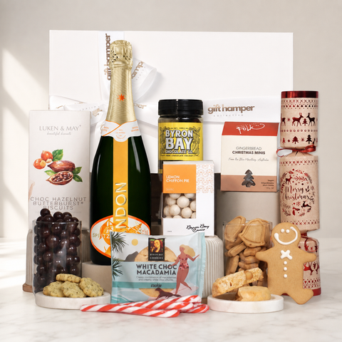Assorted gourmet food items including a Chandon Garden Spritz, cookies, and chocolate on a white background.