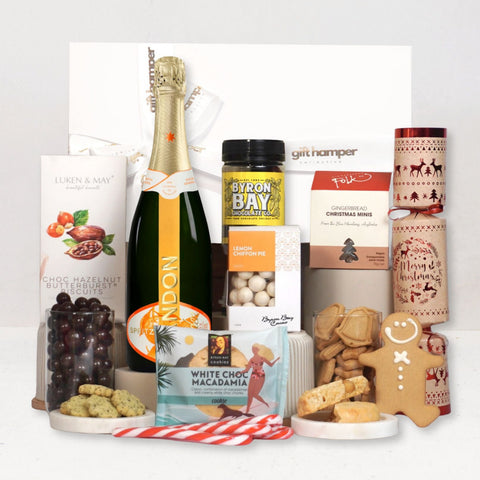Assorted gourmet food items including a Chandon Garden Spritz, cookies, and chocolate on a white background.