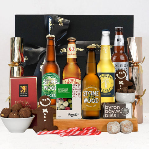 Gift basket with various beer bottles and snacks on a white background